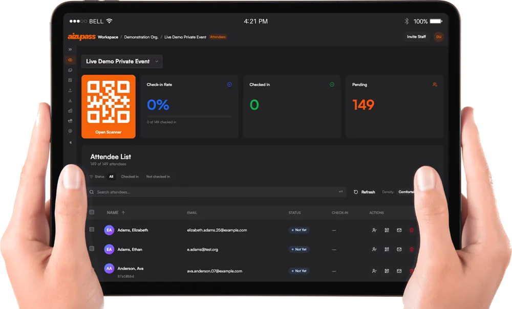 Hands holding an iPad running AizuPass — live event dashboard with QR scanner, check-in rate, and attendee list.